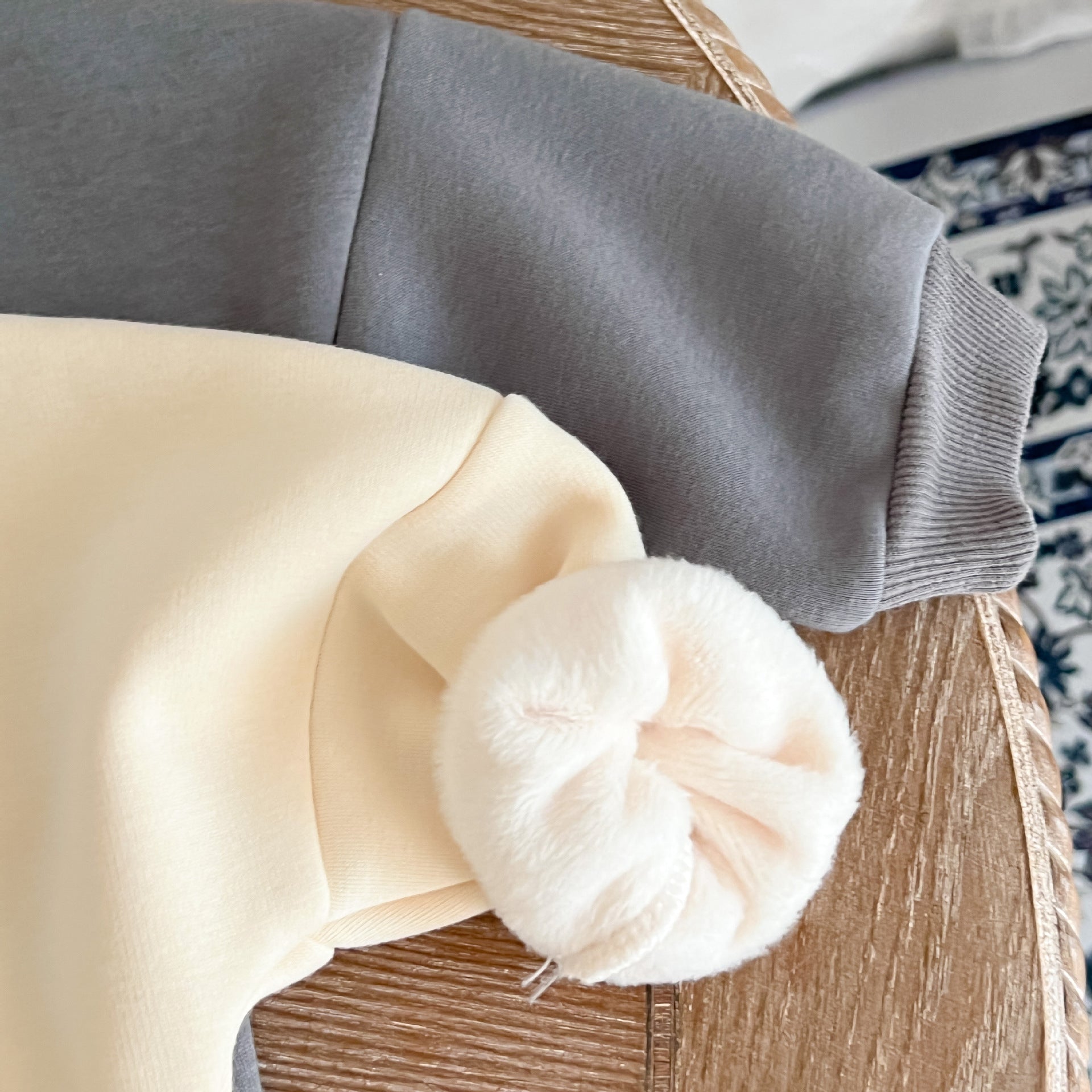 A cozy baby pullover onesie featuring a playful dinosaur print, perfect for autumn wear in apricot and brown colors.