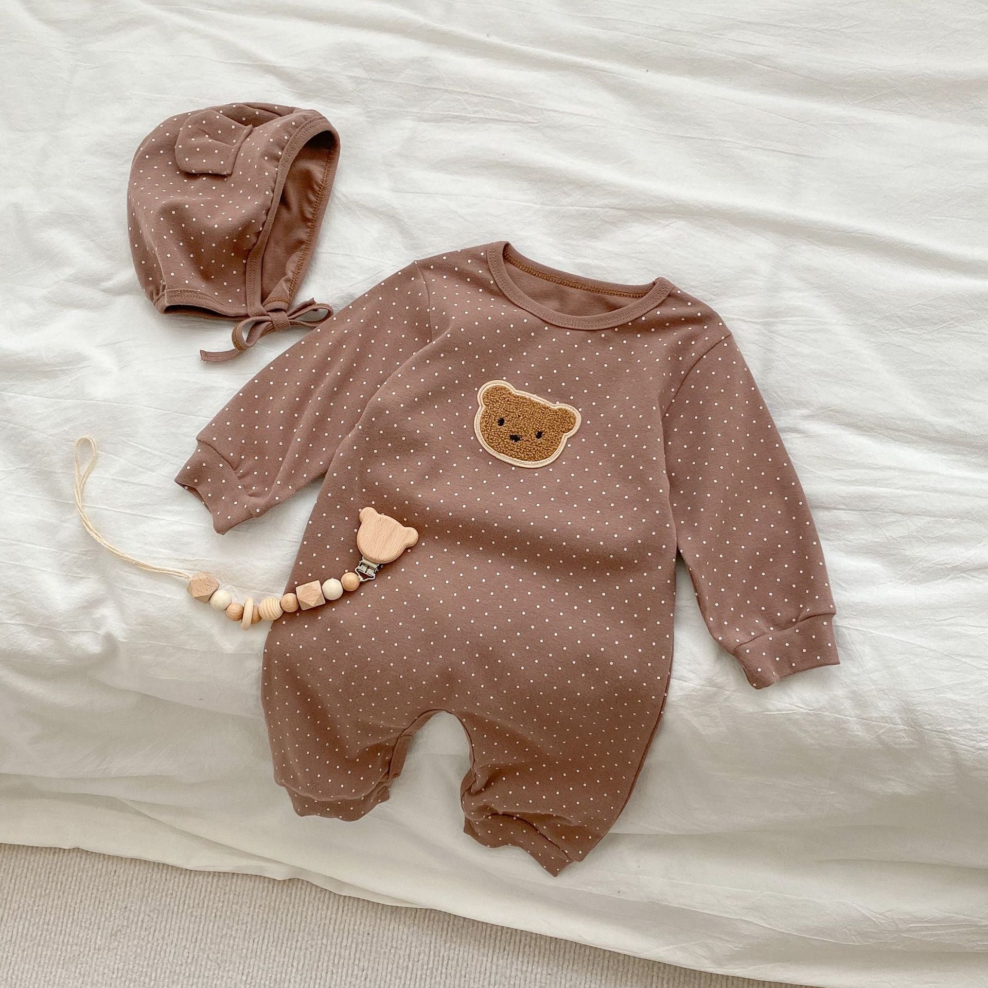 Baby jumpsuit featuring a cartoon bear design with a dot pattern, accompanied by a matching hat, perfect for infants.