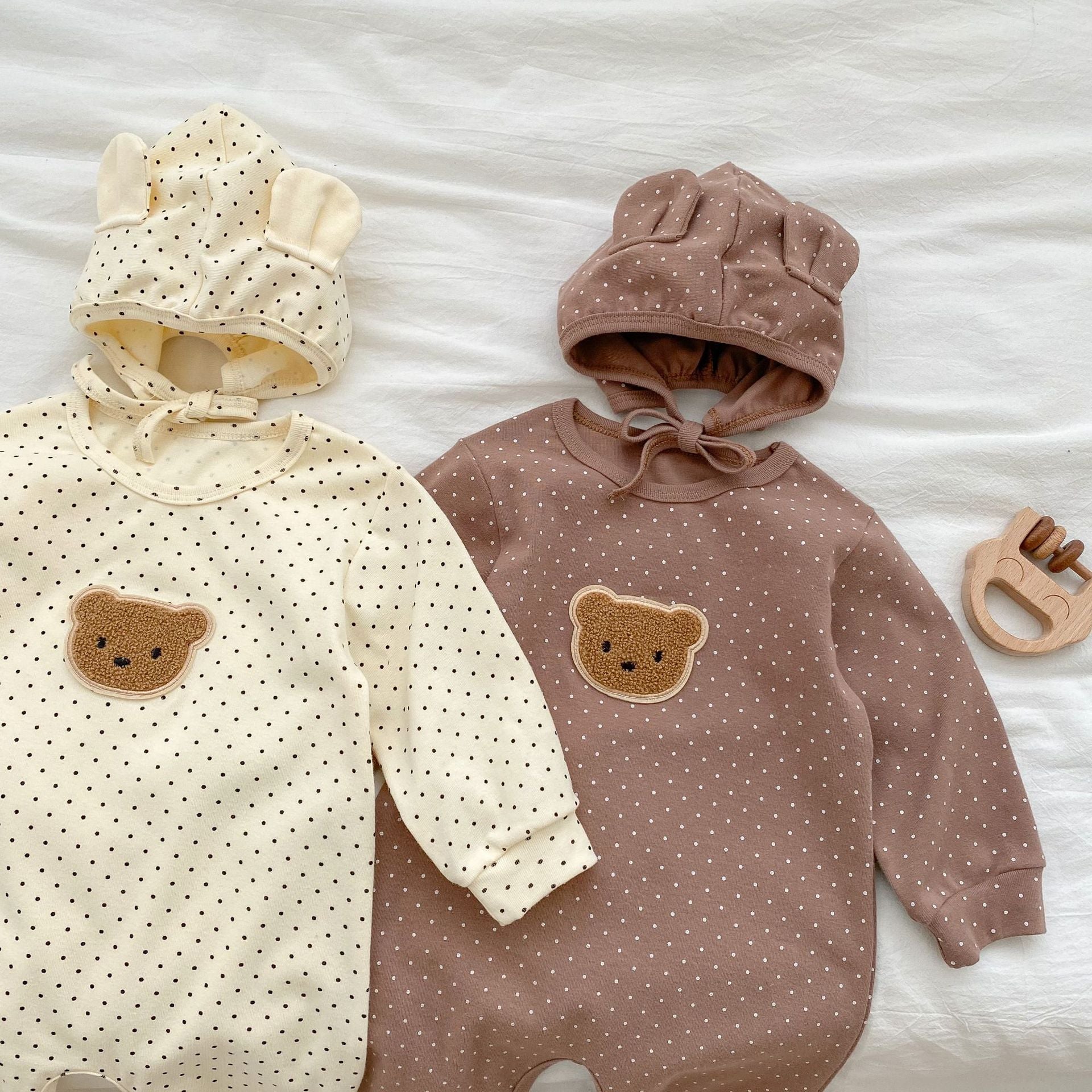 Baby jumpsuit featuring a cartoon bear design with a dot pattern, accompanied by a matching hat, perfect for infants.