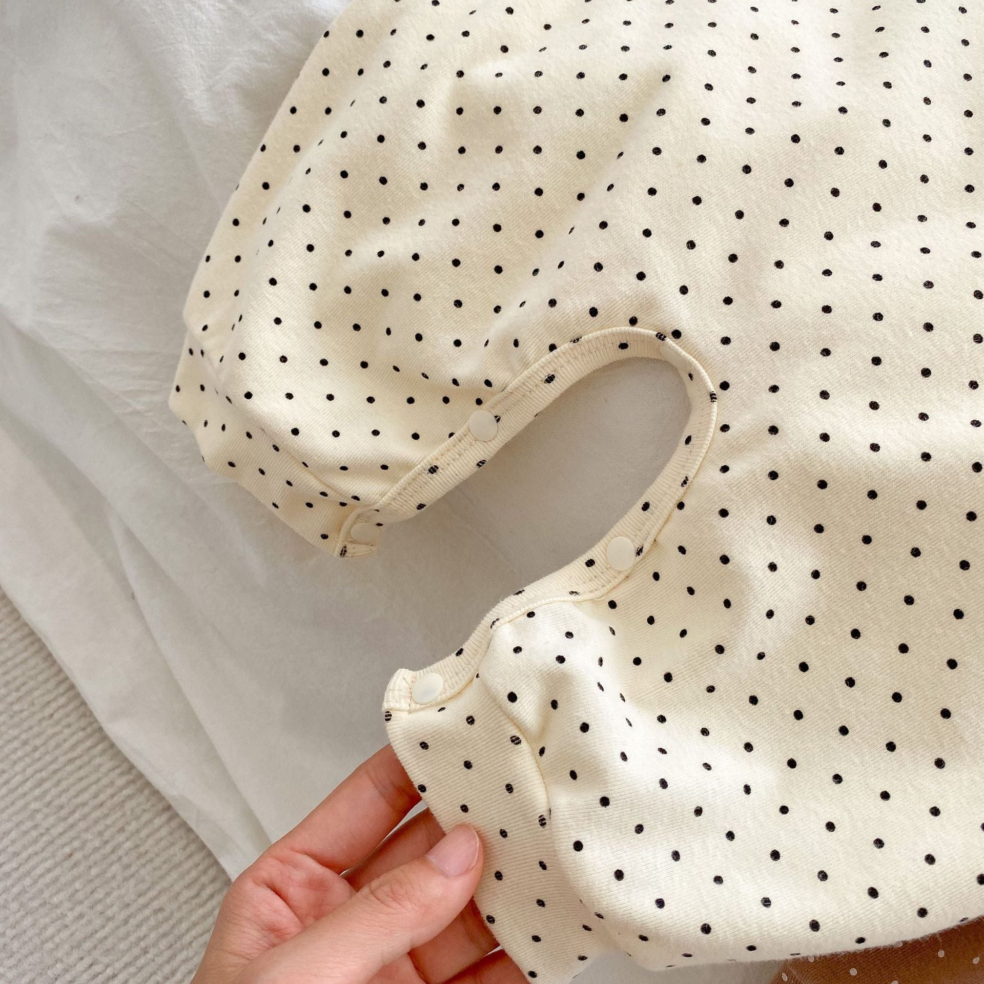 Baby jumpsuit featuring a cartoon bear design with a dot pattern, accompanied by a matching hat, perfect for infants.