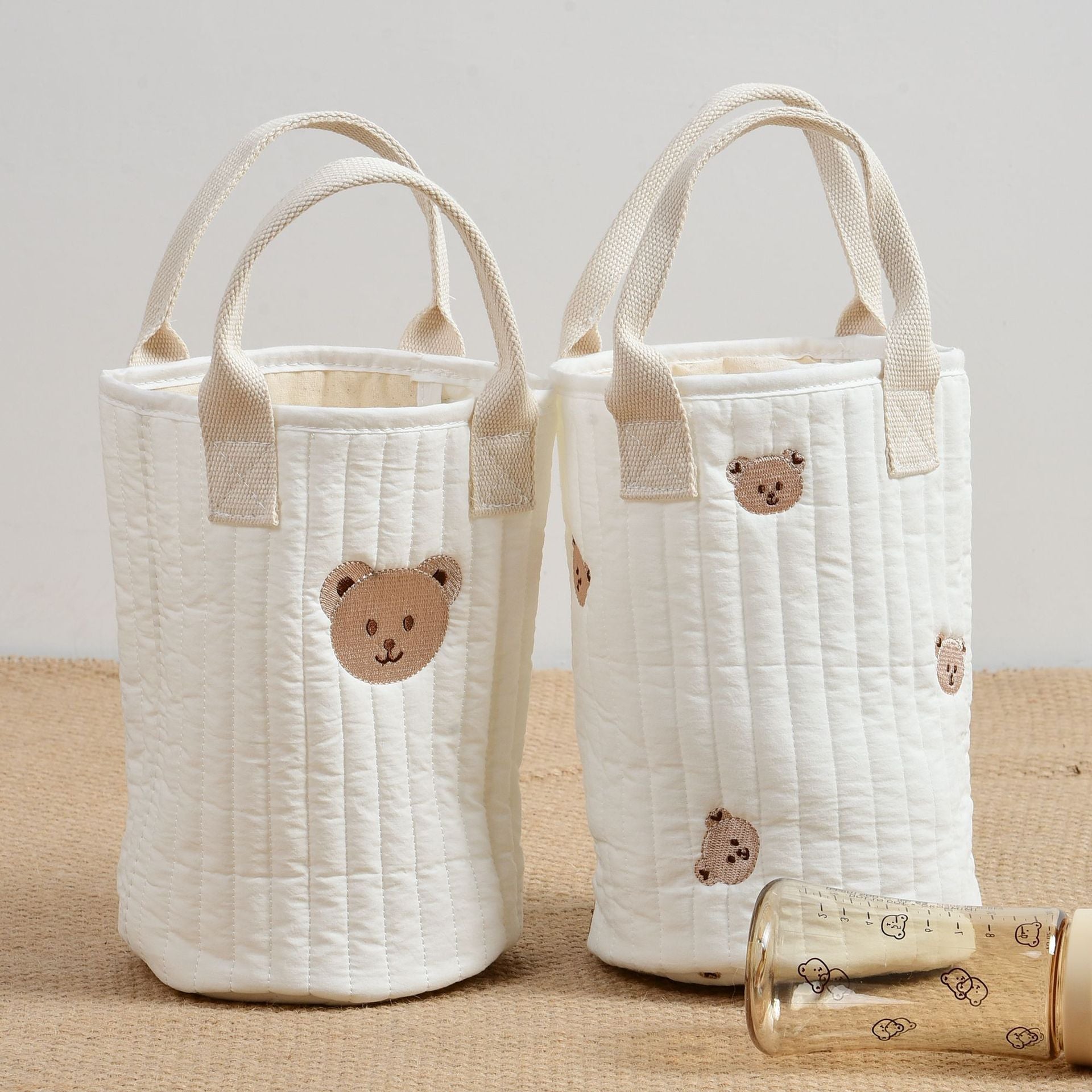 Stylish Baby Embroidered Pattern Mommy Handbag with multiple compartments for baby bottle storage, featuring adjustable straps and floral embroidery.