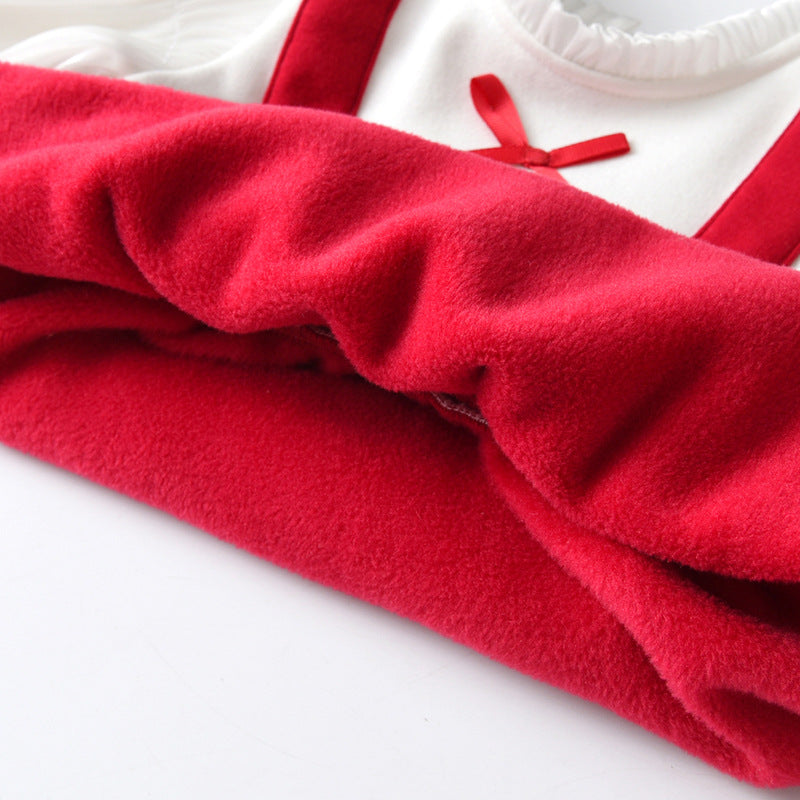 A cute baby girl wearing a long sleeve onesie with a bow patch design in red color, perfect for chilly weather.