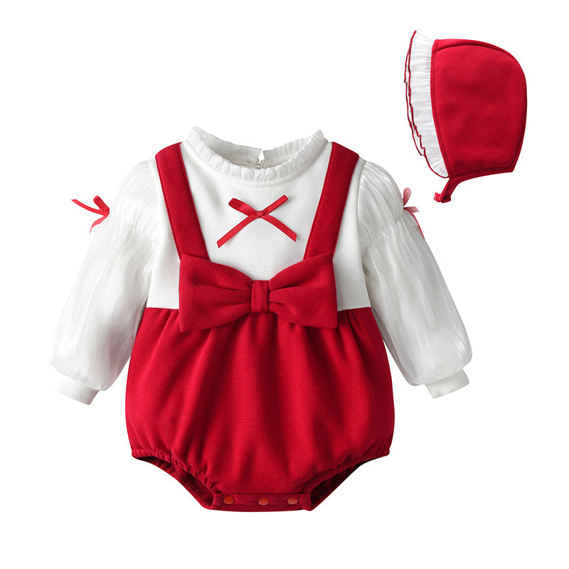 A cute baby girl wearing a long sleeve onesie with a bow patch design in red color, perfect for chilly weather.