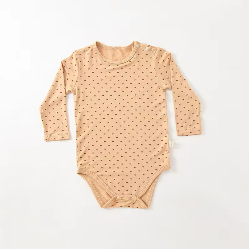 Soft cotton long sleeved onesies for babies featuring floral and heart patterns in white, pink, blue, and apricot colors.