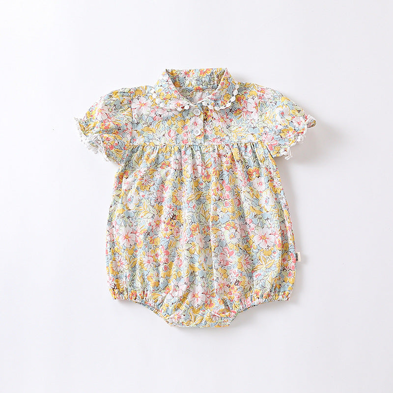 Baby girl wearing a floral pattern onesie in yellow and apricot, showcasing a stylish summer outfit.
