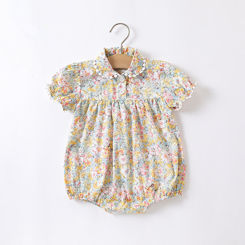 Baby girl wearing a floral pattern onesie in yellow and apricot, showcasing a stylish summer outfit.