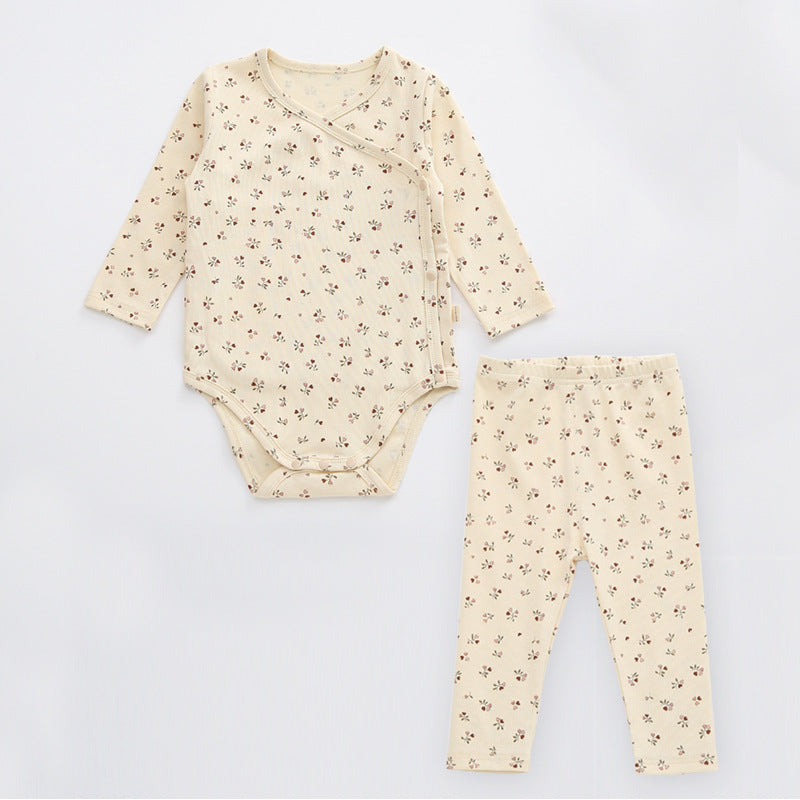 A cute baby outfit featuring a floral print pattern with a side buckle design, perfect for warm weather.