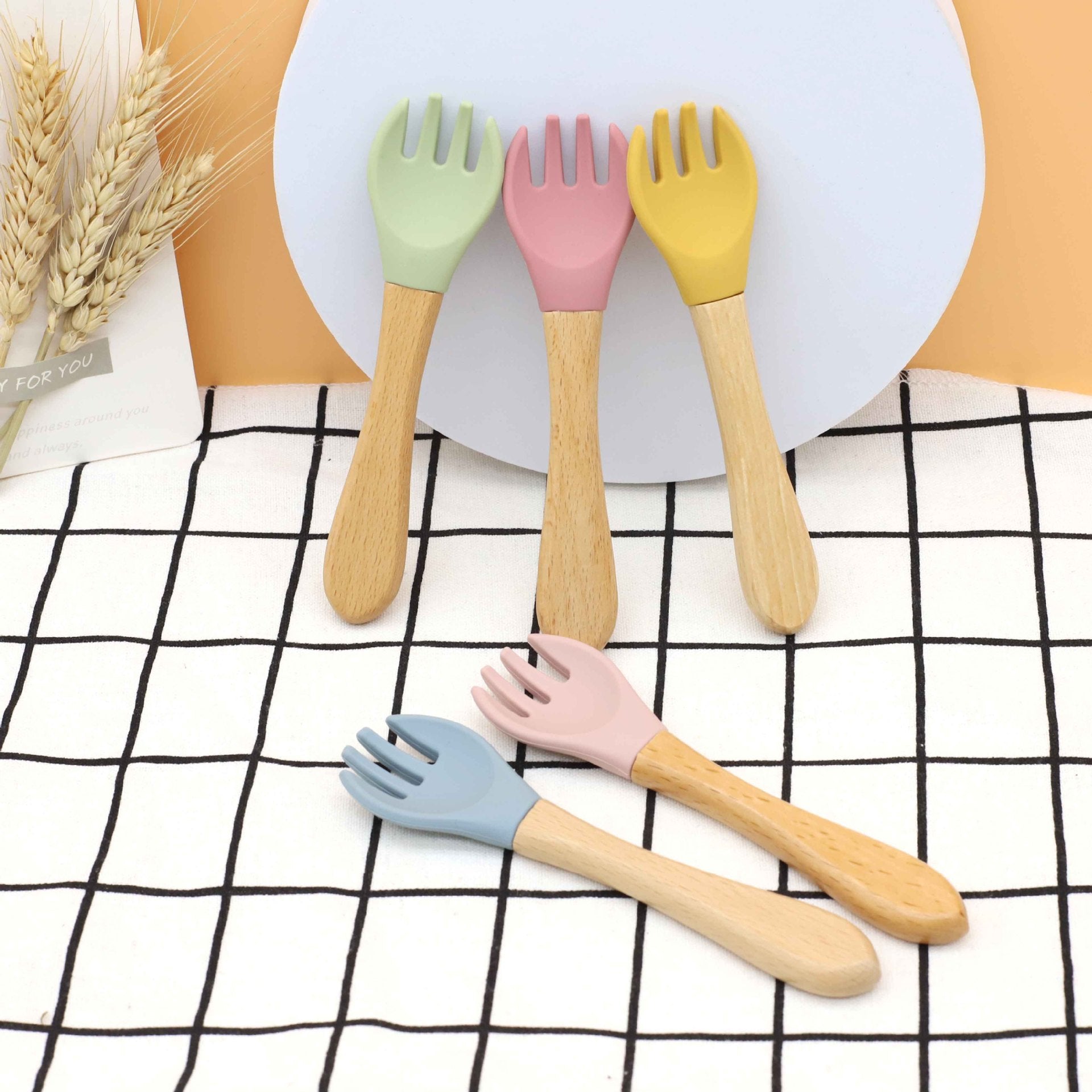 Baby Food Grade Wooden Handles Silicone Spoon Fork Cutlery set in various colors with soft silicone and wooden handles.