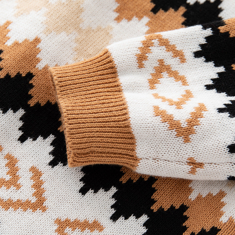 Baby girl wearing a brown geometric embroidered long sleeve knitted romper jumpsuit, showcasing playful design and comfort.