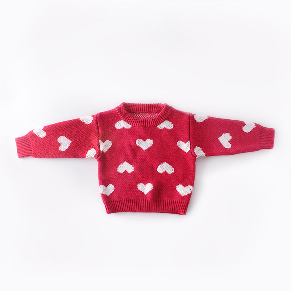 Baby girl wearing a red pullover sweater with heart embroidery, showcasing a cozy and stylish look.