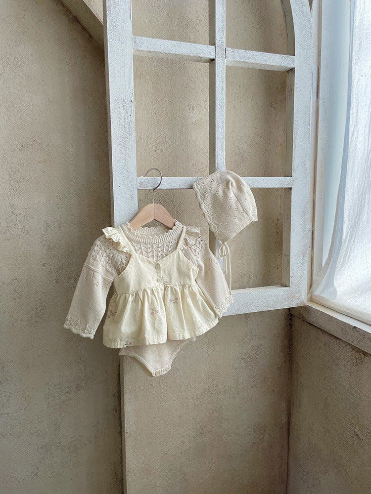 Baby girl wearing a floral embroidered ruffle sling top and shorts set in apricot color, showcasing delicate embroidery and ruffles.