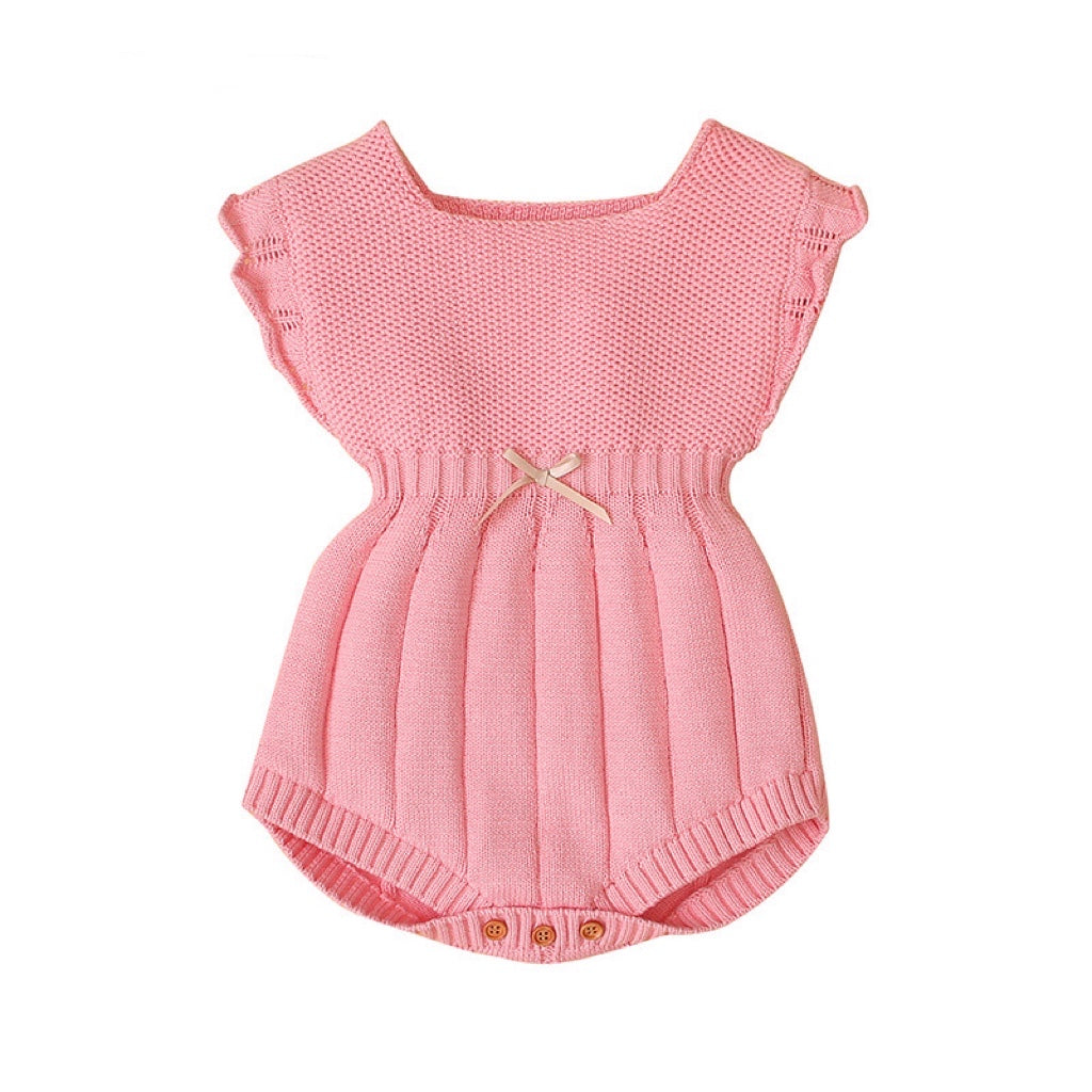 Baby girl wearing a ribbed knitted onesie with ruffle design in pink color, showcasing a stylish and comfortable outfit.