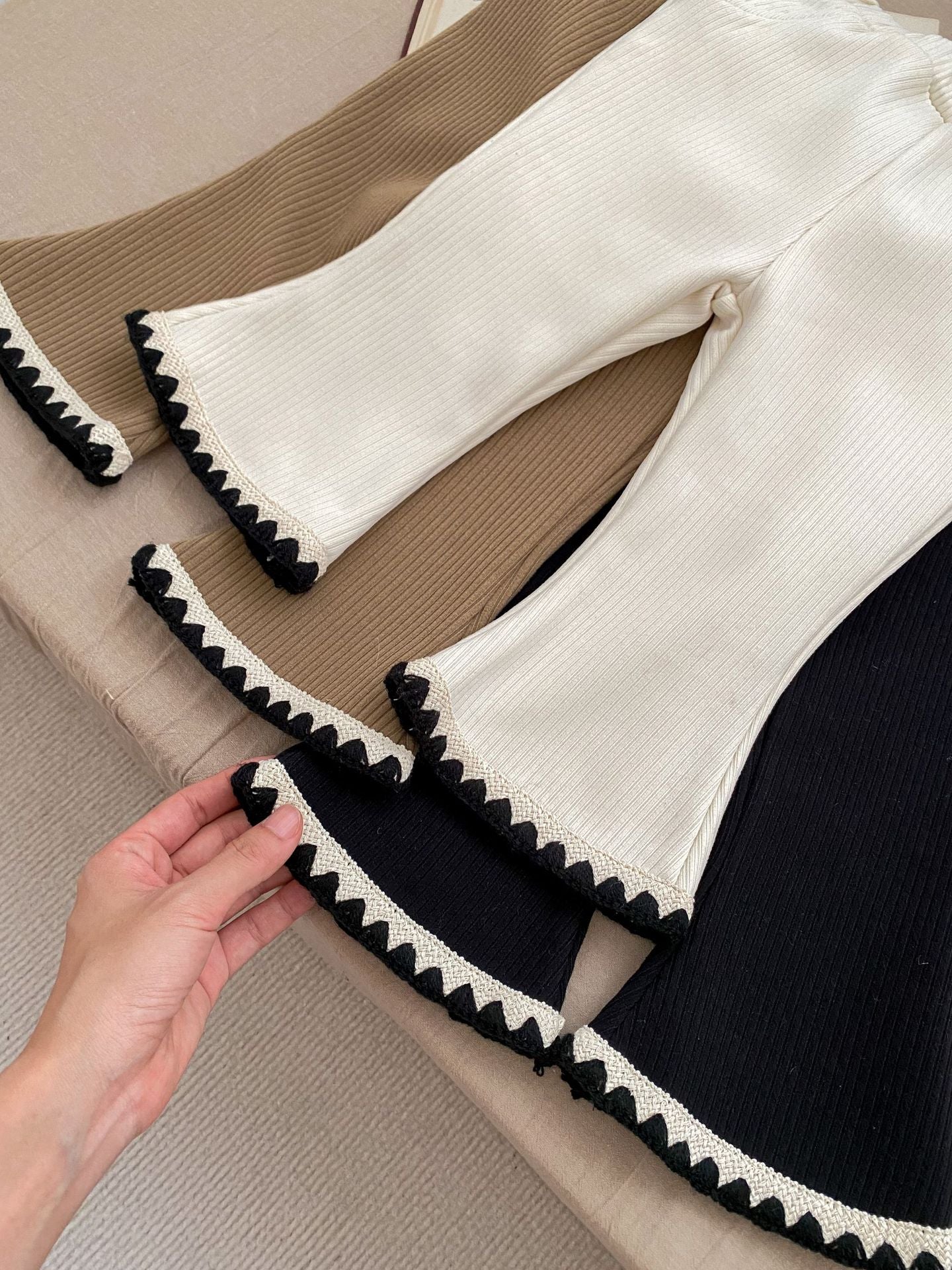 Baby girl flared pants in black, beige, and brown colors, made of soft cotton, perfect for winter wear.