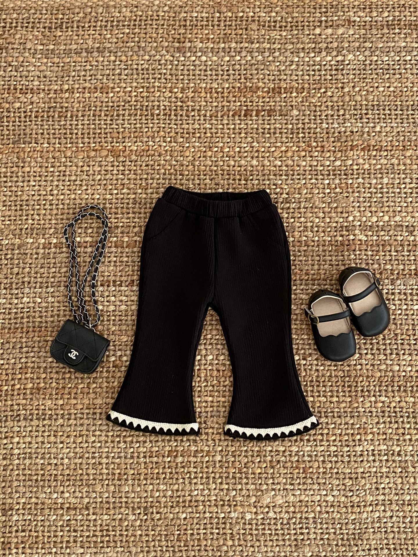 Baby girl flared pants in black, beige, and brown colors, made of soft cotton, perfect for winter wear.