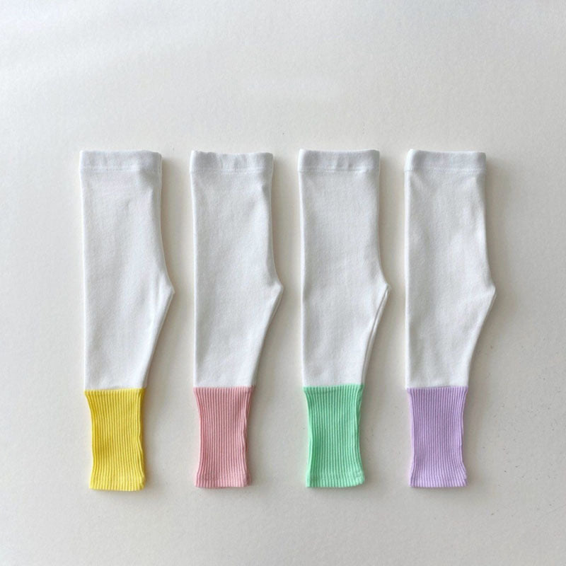 Baby girl candy color patchwork design tight bottom pants in pink, purple, green, and yellow, made from soft cotton material.