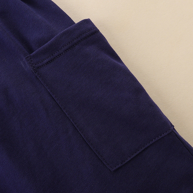 A cute navy blue sleeveless dress for baby girls featuring playful cartoon graphics, perfect for summer wear.