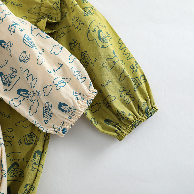 Baby girl wearing a soft cotton bodysuit with a cartoon pattern in green and apricot colors.