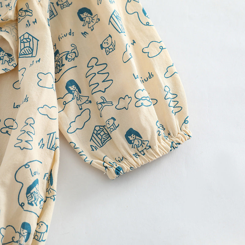 Baby girl wearing a soft cotton bodysuit with a cartoon pattern in green and apricot colors.