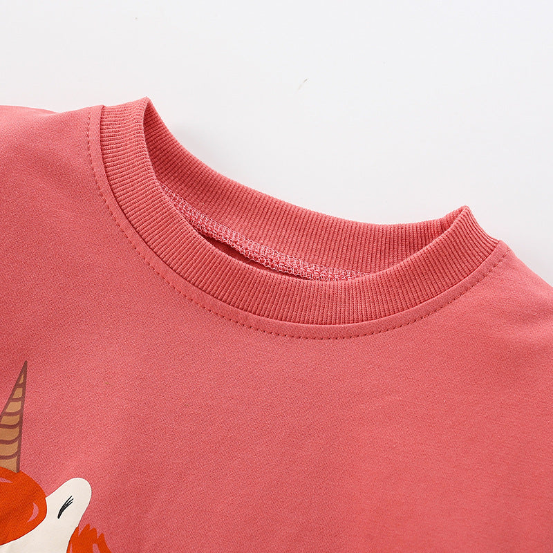 Baby girl wearing a cozy orange terry hoodie with a unicorn cartoon print, perfect for spring and autumn.