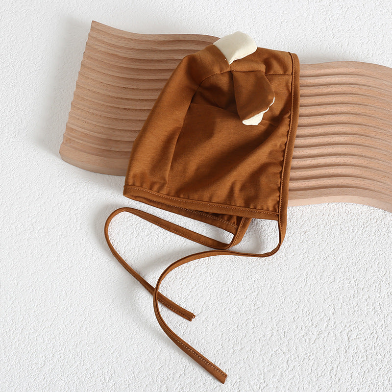 Baby girl wearing a cute cartoon sheep onesie with a round collar and a matching hat, perfect for summer.