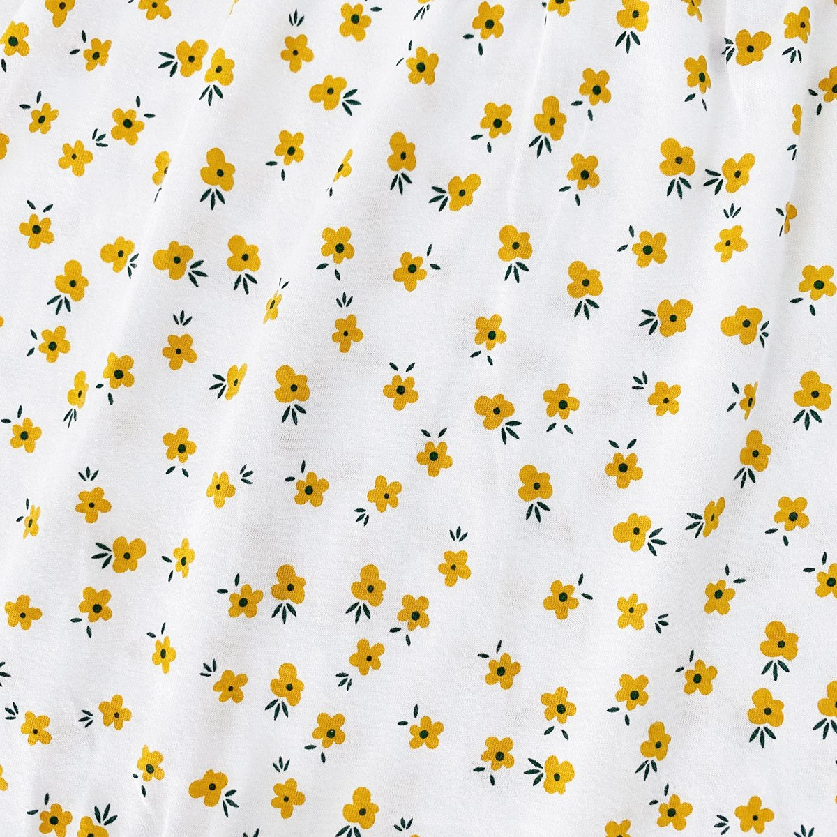 Baby girl romper featuring a ditsy floral print and embroidered carrot pattern, available in pink and yellow colors.