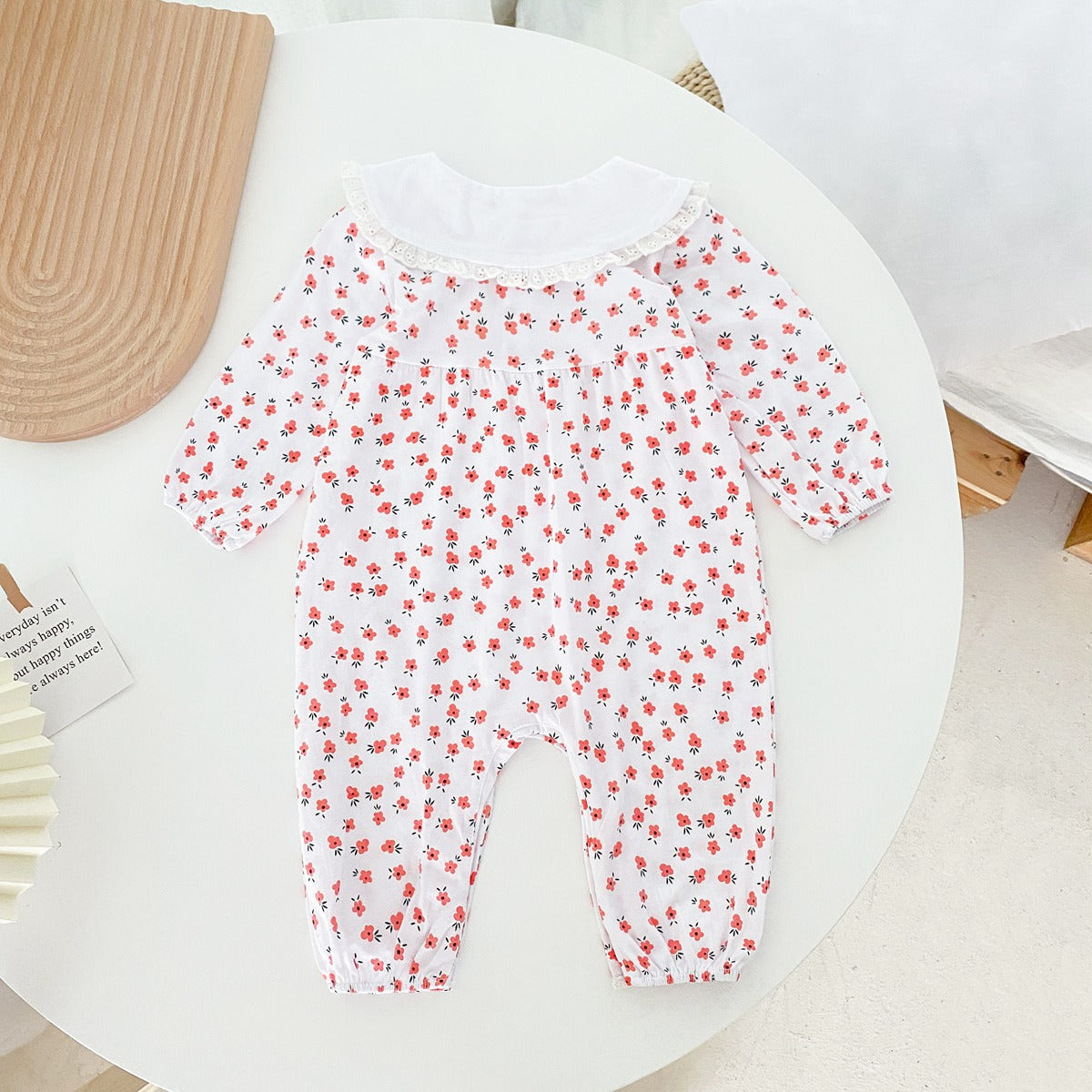 Baby girl romper featuring a ditsy floral print and embroidered carrot pattern, available in pink and yellow colors.
