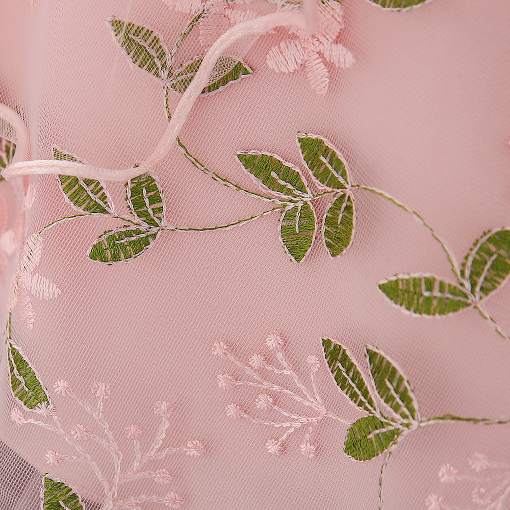 Baby girl wearing an elegant embroidered pattern tutu formal dress with medium sleeves in pink color.