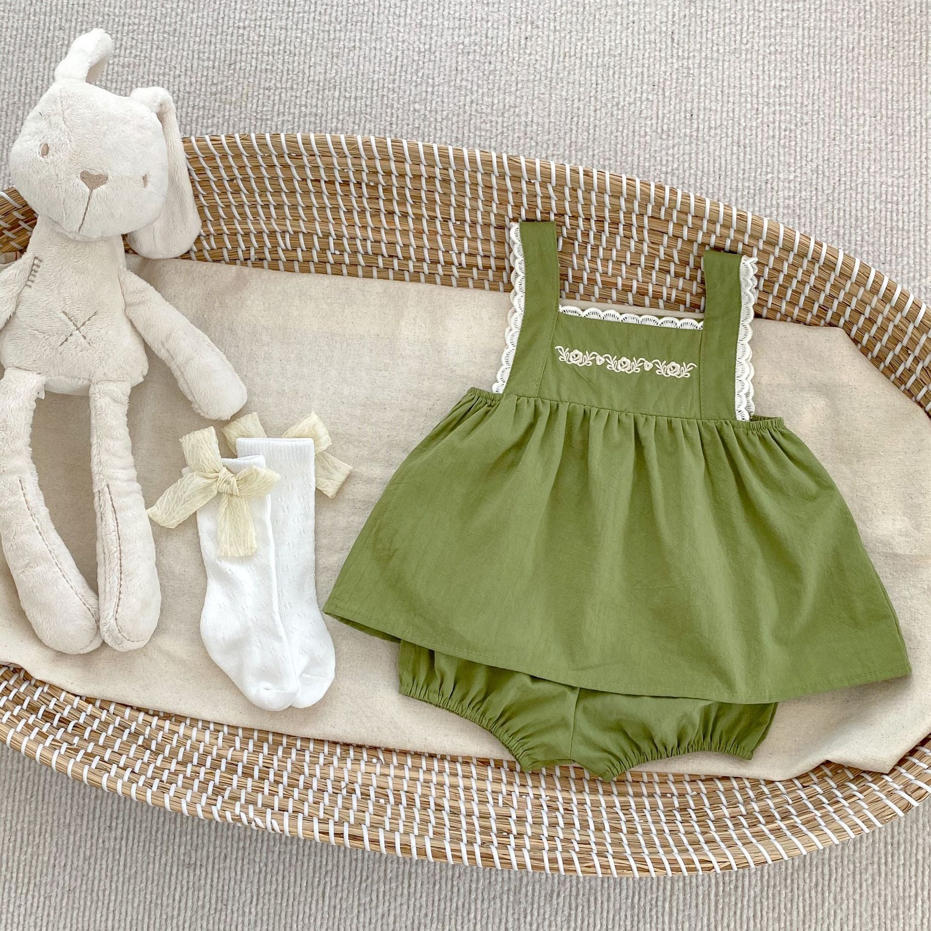 Baby girl wearing a green embroidery pattern sling top with shorts, showcasing floral designs and a comfortable fit.