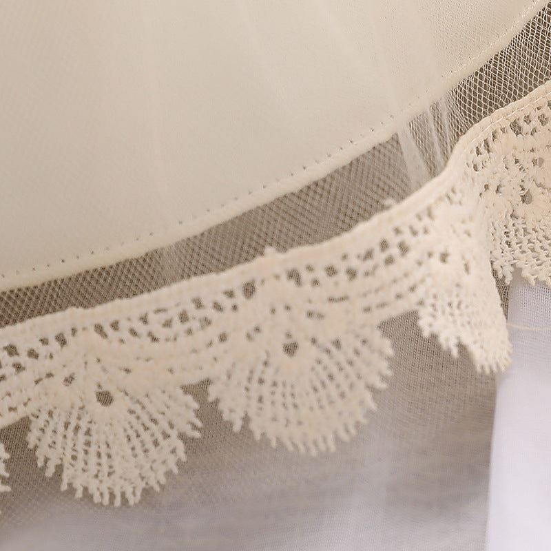 Baby girl wearing a floral embroidered christening dress with sequins and a tutu style, showcasing elegance and charm.