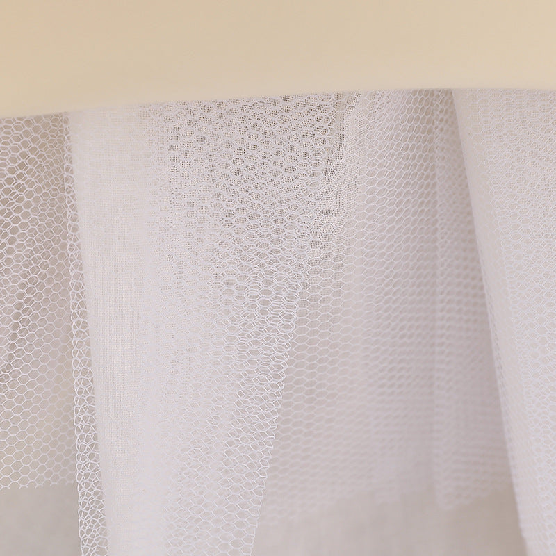 Baby girl wearing a floral embroidered christening dress with sequins and a tutu style, showcasing elegance and charm.
