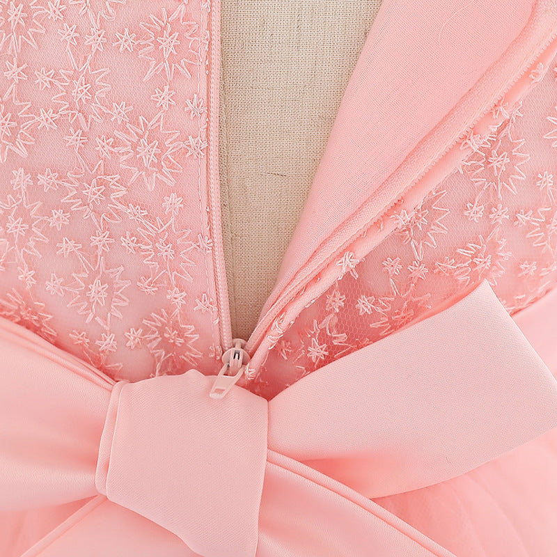 Baby girl wearing a floral embroidered christening dress with sequins and a tutu style, showcasing elegance and charm.