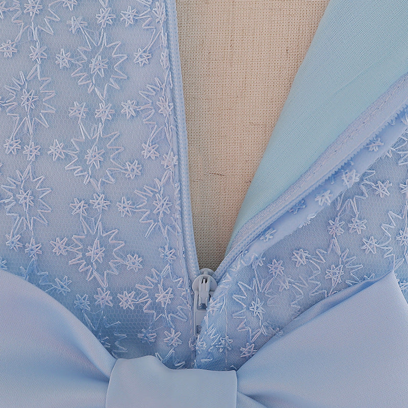 Baby girl wearing a floral embroidered christening dress with sequins and a tutu style, showcasing elegance and charm.