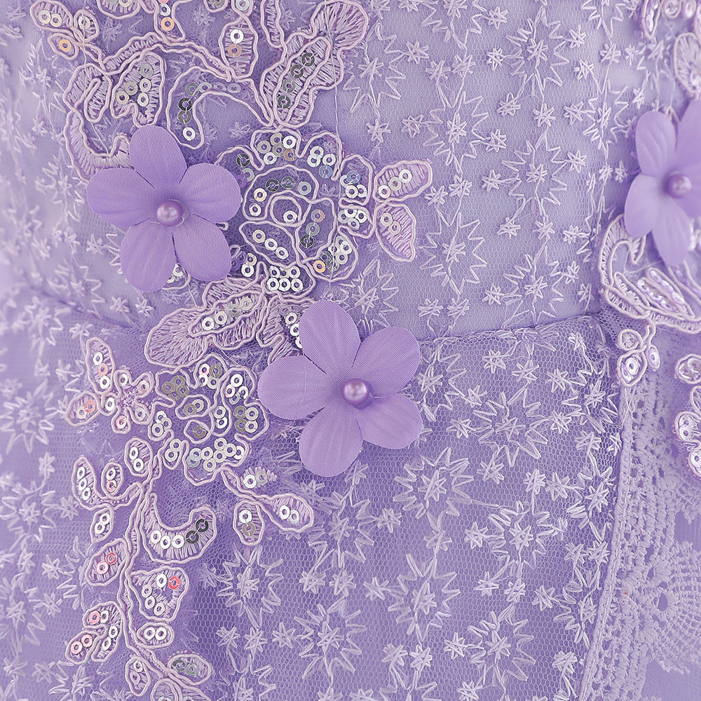 Baby girl wearing a floral embroidered christening dress with sequins and a tutu style, showcasing elegance and charm.