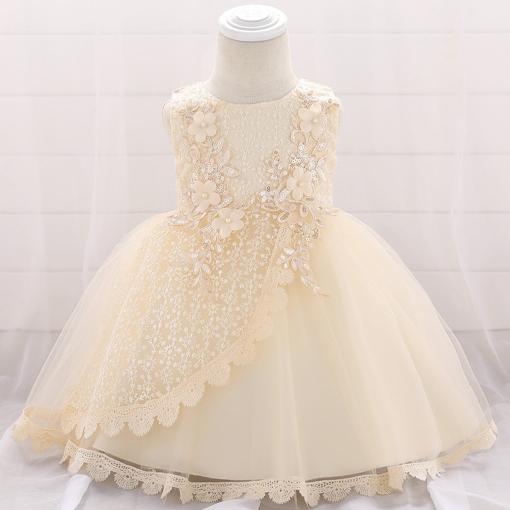 Baby girl wearing a floral embroidered christening dress with sequins and a tutu style, showcasing elegance and charm.
