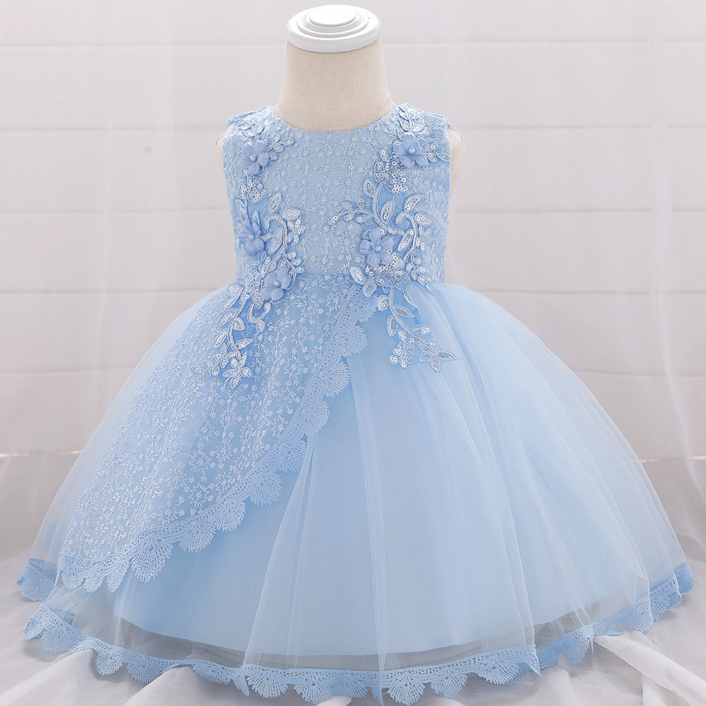 Baby girl wearing a floral embroidered christening dress with sequins and a tutu style, showcasing elegance and charm.
