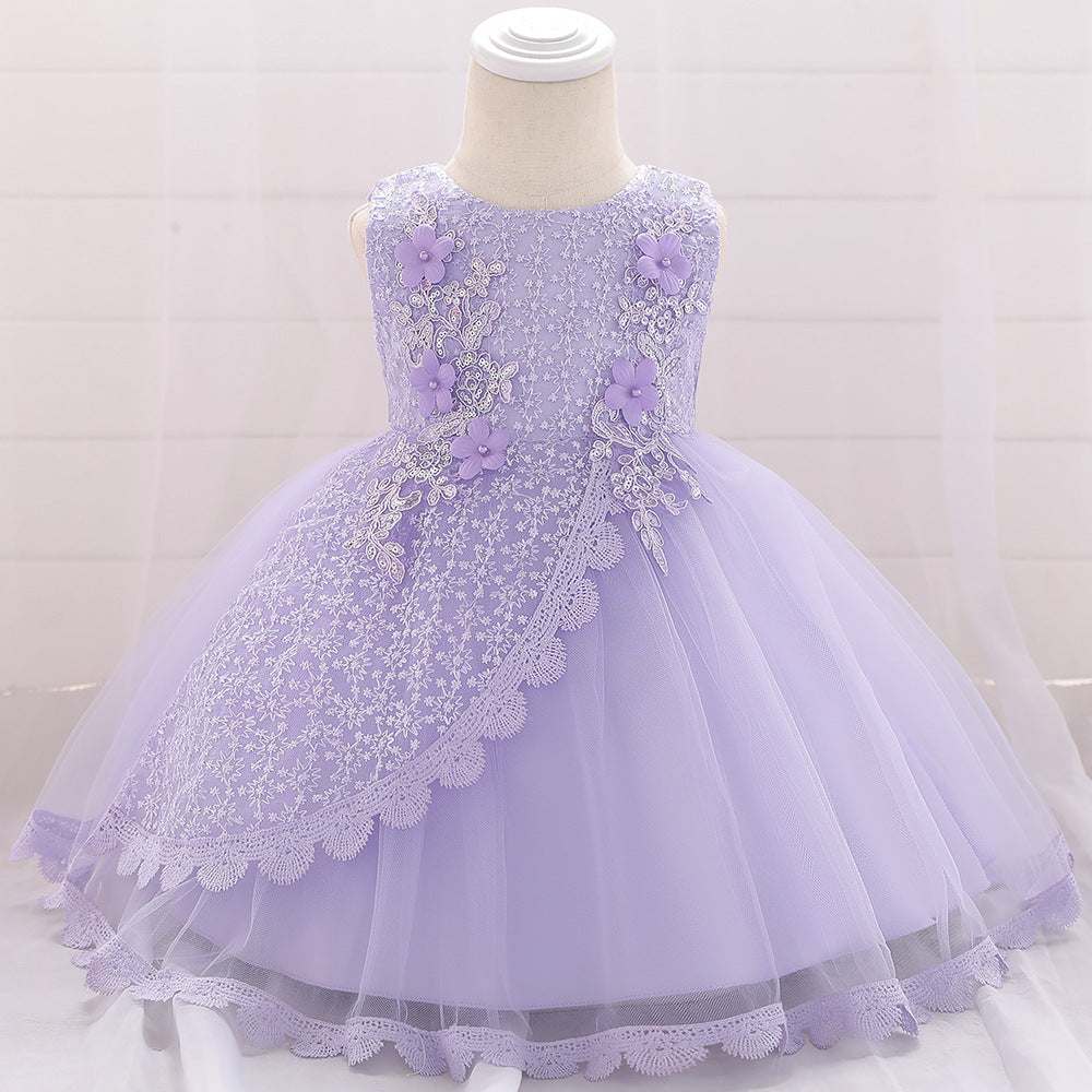 Baby girl wearing a floral embroidered christening dress with sequins and a tutu style, showcasing elegance and charm.