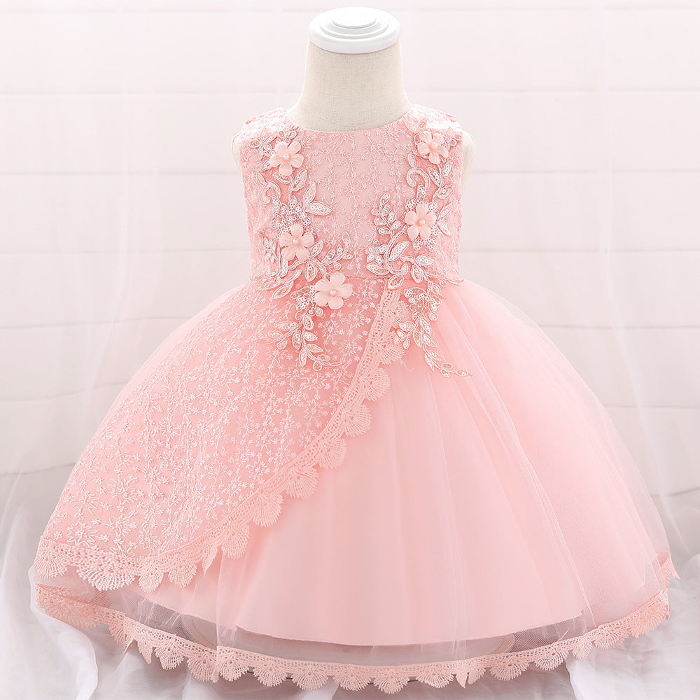 Baby girl wearing a floral embroidered christening dress with sequins and a tutu style, showcasing elegance and charm.