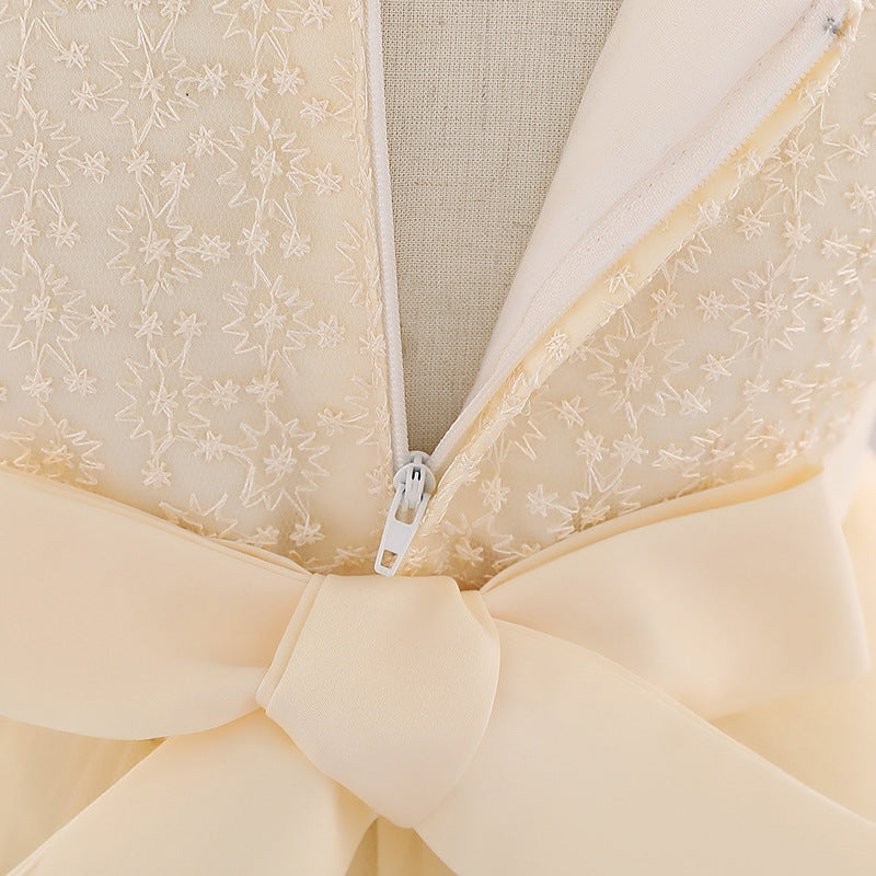 Baby girl wearing a floral embroidered christening dress with sequins and a tutu style, showcasing elegance and charm.