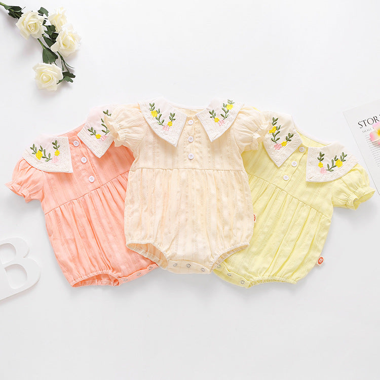 Baby girl onesie featuring floral embroidery design in pink, yellow, and beige colors, perfect for summer wear.