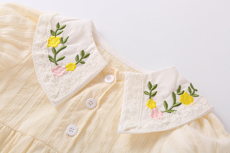 Baby girl onesie featuring floral embroidery design in pink, yellow, and beige colors, perfect for summer wear.