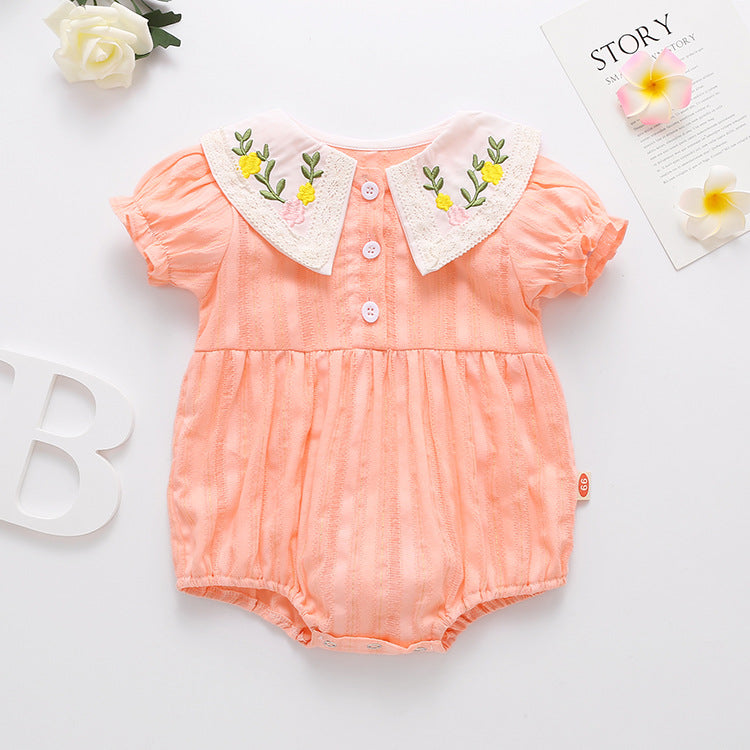 Baby girl onesie featuring floral embroidery design in pink, yellow, and beige colors, perfect for summer wear.