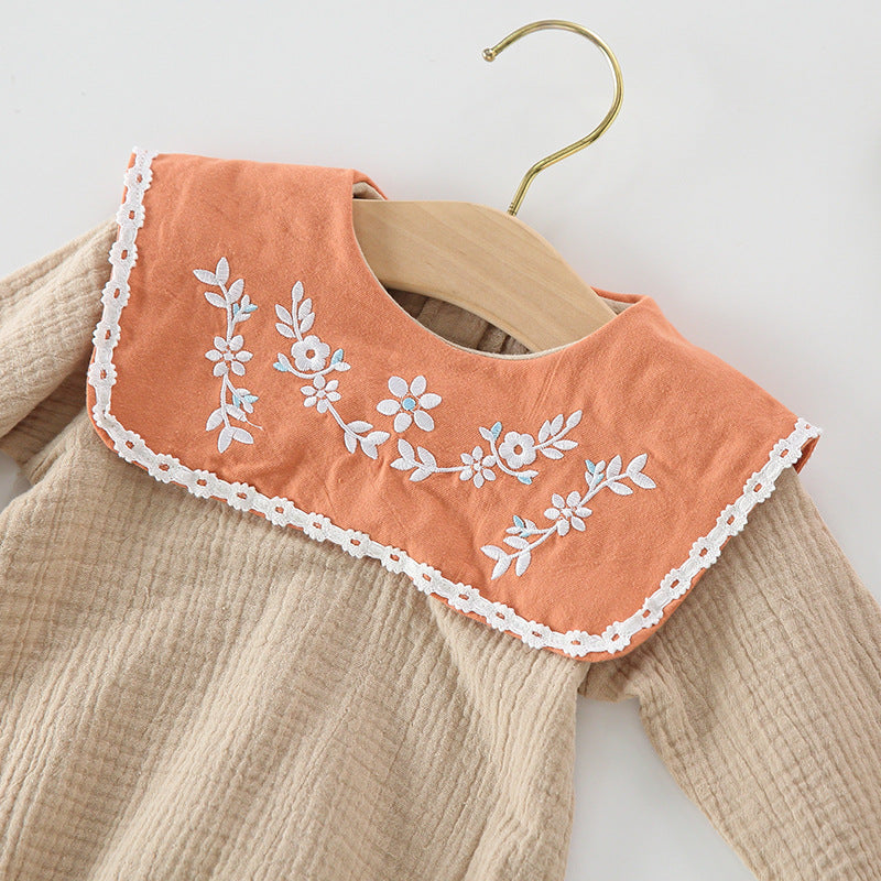 Baby girl wearing a floral embroidered bodysuit with long sleeves and a matching hat, perfect for autumn.