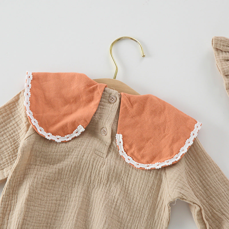 Baby girl wearing a floral embroidered bodysuit with long sleeves and a matching hat, perfect for autumn.