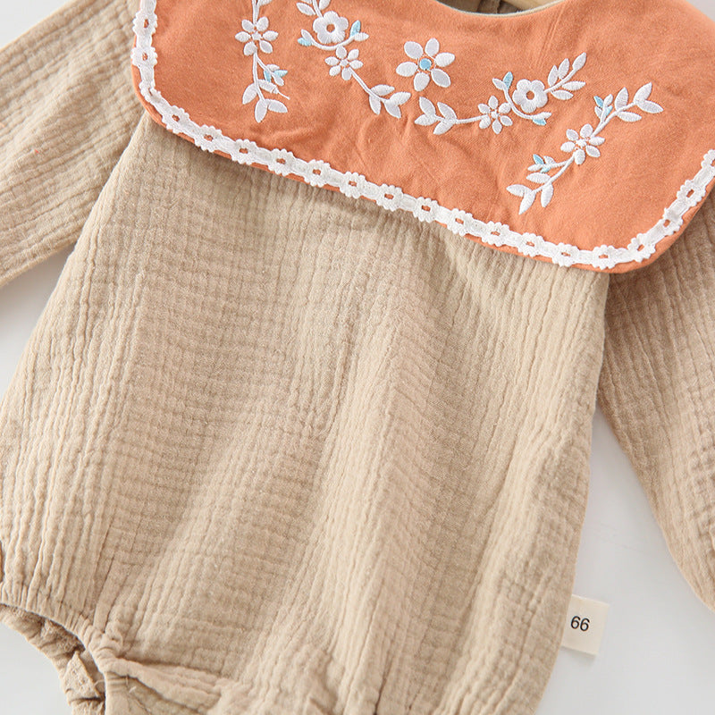 Baby girl wearing a floral embroidered bodysuit with long sleeves and a matching hat, perfect for autumn.