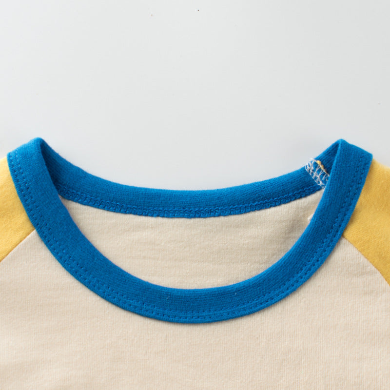 A vibrant yellow long sleeve top for baby girls featuring a colorful floral graphic design, made from soft cotton material.