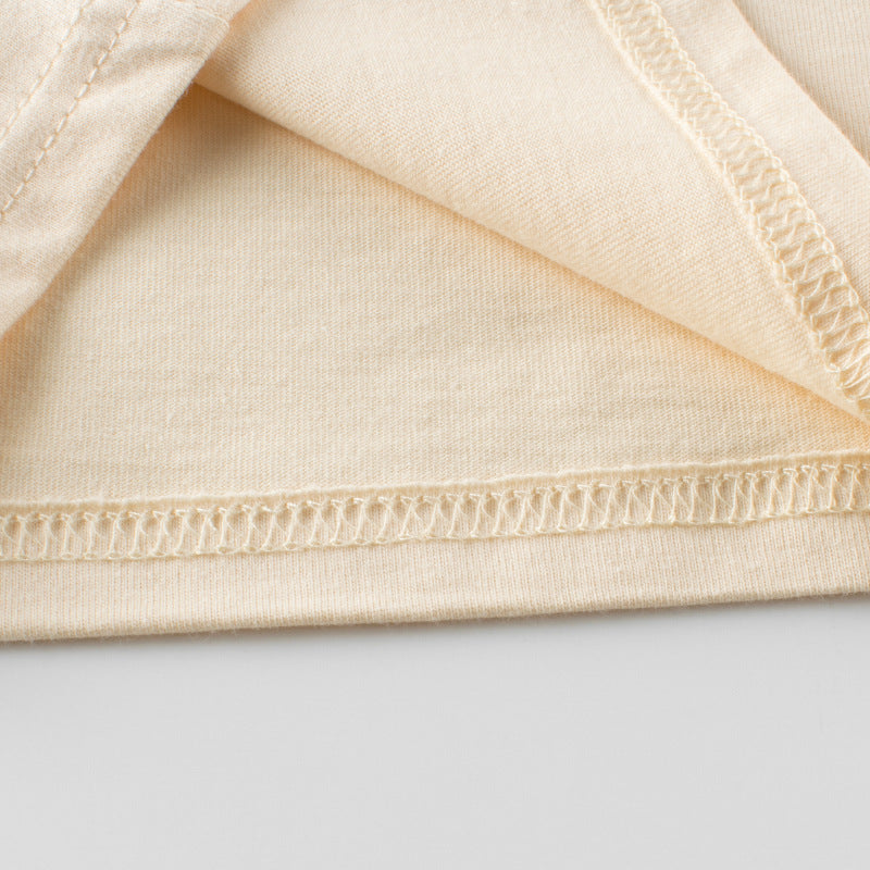 A vibrant yellow long sleeve top for baby girls featuring a colorful floral graphic design, made from soft cotton material.