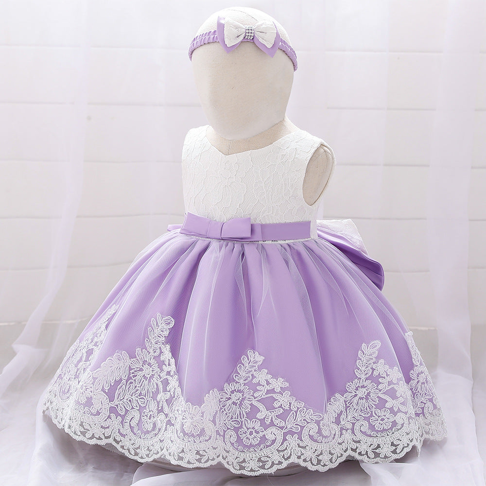 Baby girl wearing a floral mesh overlay formal dress with matching headband, perfect for special occasions.