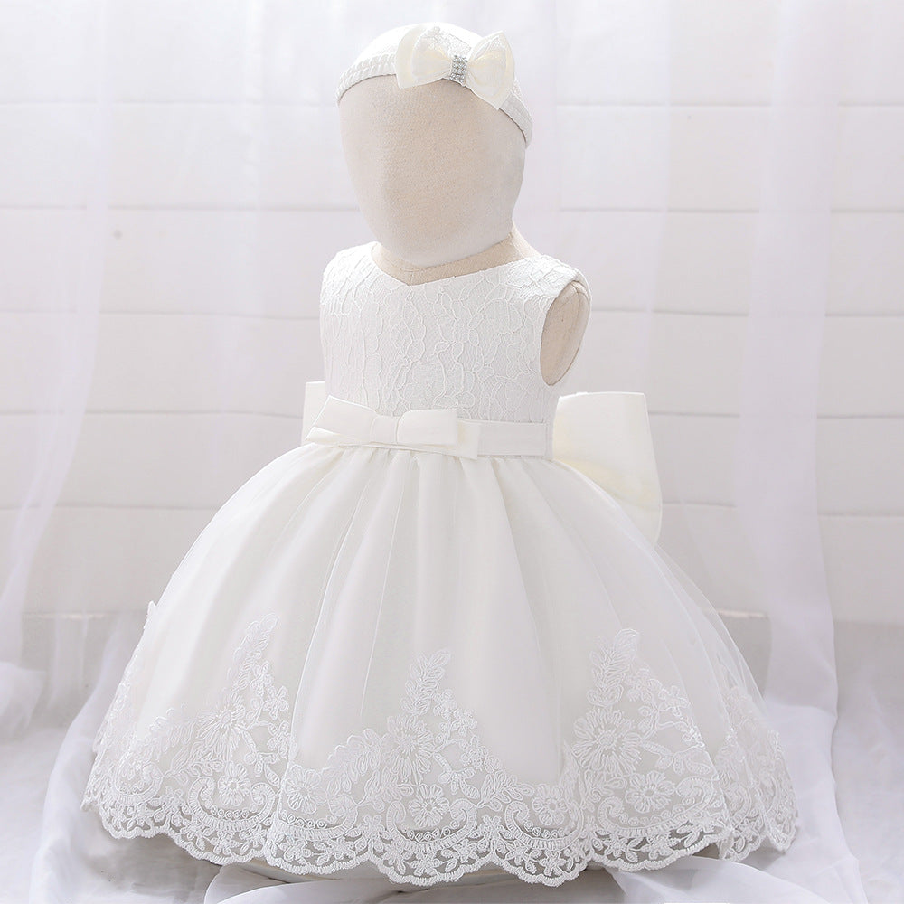 Baby girl wearing a floral mesh overlay formal dress with matching headband, perfect for special occasions.