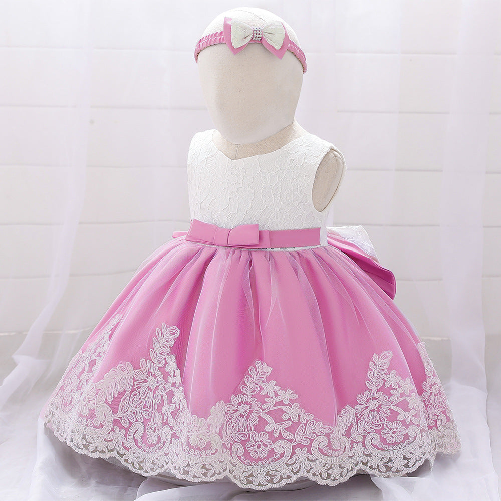 Baby girl wearing a floral mesh overlay formal dress with matching headband, perfect for special occasions.
