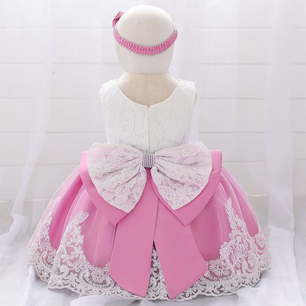 Baby girl wearing a floral mesh overlay formal dress with matching headband, perfect for special occasions.